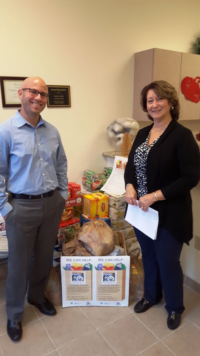 Attorney Jonathan Karp and Paralegal Janet Suarez with the 452 pounds of food our firm contributed to the community food drive