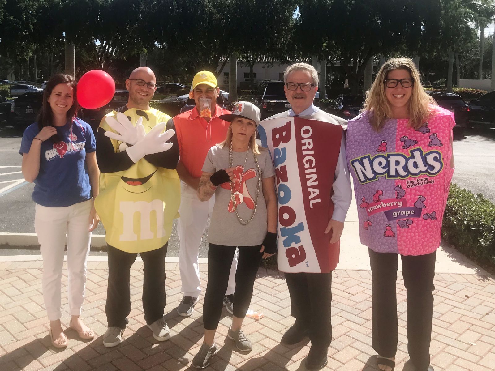 (L-R) Dressed as their favorite Halloween candy: Attorneys Cara Stropp (Airheads), Jonathan Karp (M&Ms), Andrew Gindea (candy corn); Firm Administrator Audrey Yeager (Gummy Bears); and Attorneys Joseph Karp (Bazooka bubble gum) and Adele Harris (Nerds!).